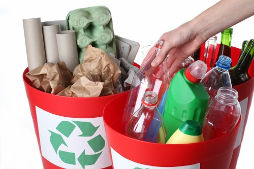 Workers separating recyclable materials during a garden clearance